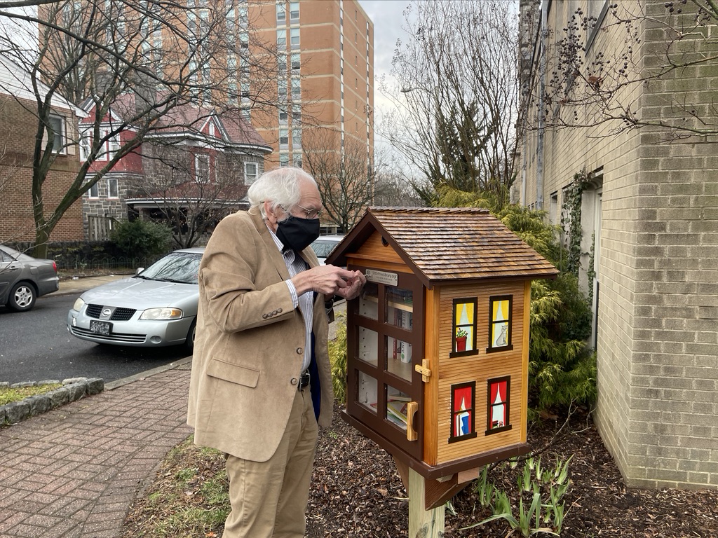 Bill Tudor adds the official plaque to our Free Little Library.